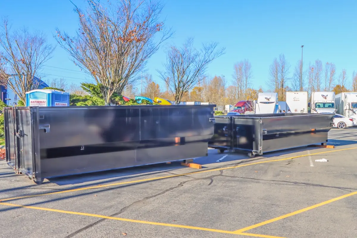 Professional dumpster rental service with roll-off container on residential driveway in Rolla